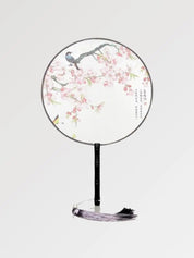 Abanico japonés uchiwa redondo Kiyosu blanco con sakura rosa y un pájaro posado Ropa Japonesa