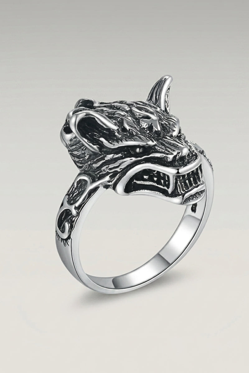 Anillo 'Matsue' — cabeza de lobo plateada con el hocico entreabierto sobre un aro fino y liso, foto de producto sobre fondo gris claro