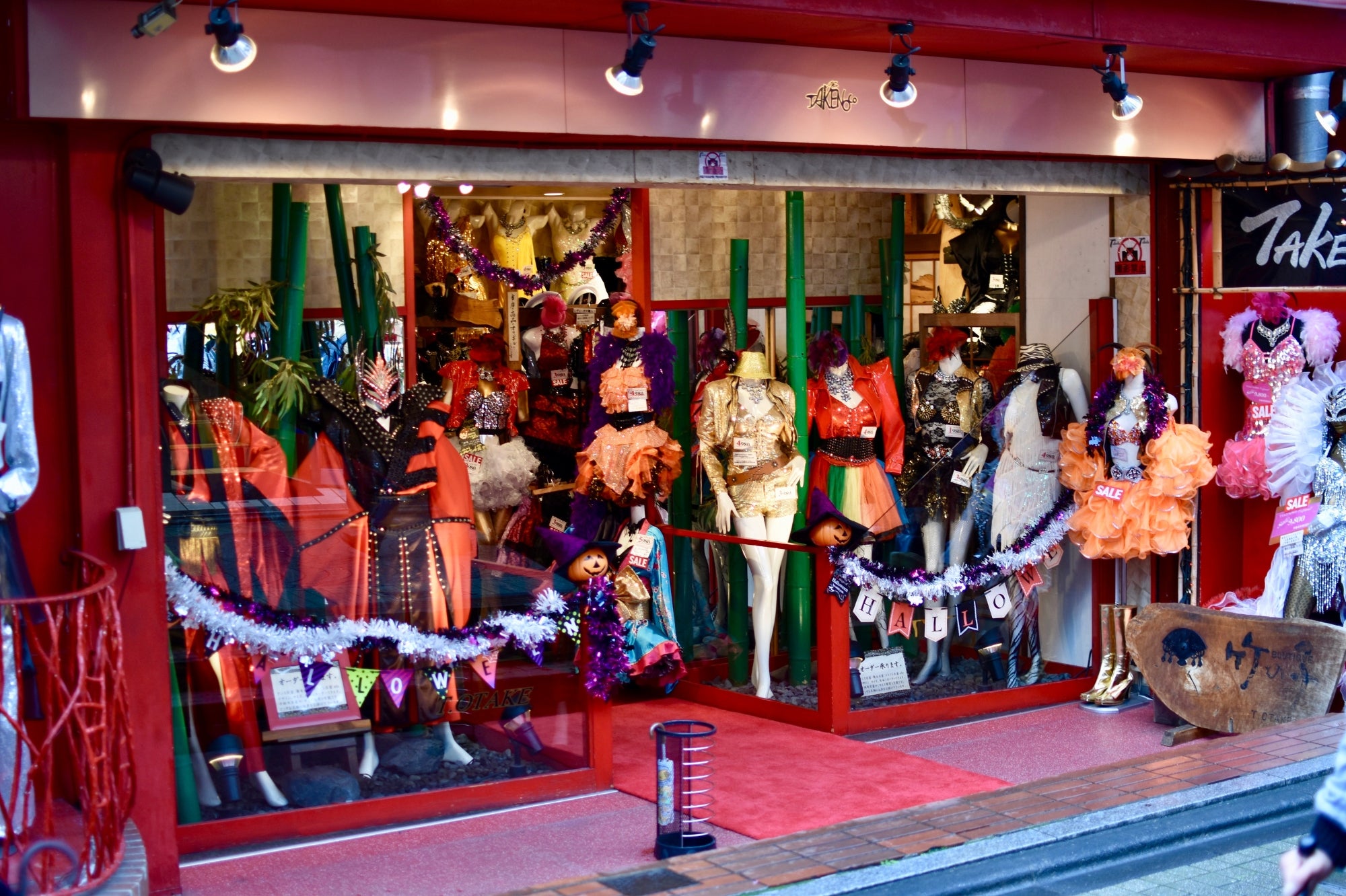 Escaparate de una tienda colorida en Harajuku con disfraces excéntricos y ropa de moda japonesa inspirada en la cultura pop.