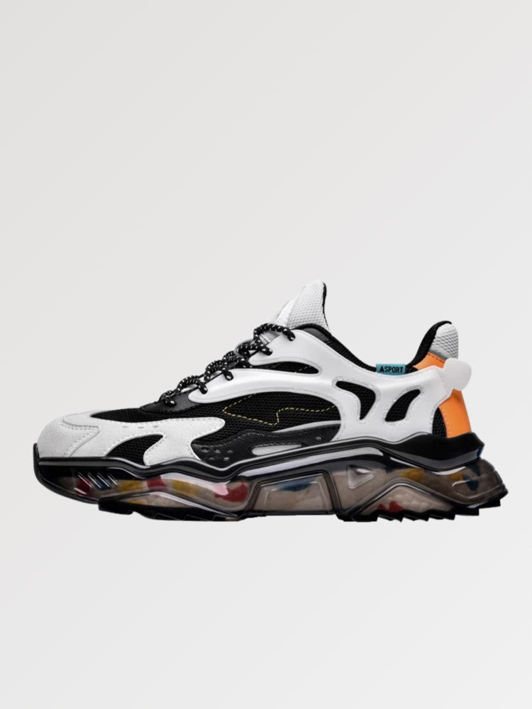 Zapatillas chunky 'Kariya' en blanco y gris — líneas onduladas blancas con acento naranja sobre suela translúcida, foto de producto sobre fondo claro