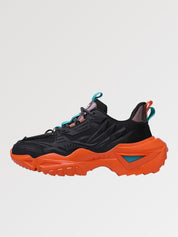 Zapatillas chunky 'Shinshiro' en negro y naranja — corte negro con detalles turquesa sobre suela naranja, foto de producto sobre fondo claro